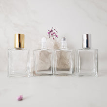 Load image into Gallery viewer, A perfume travel bottle in a rectangle shape with plastic or steel inserts and gold or silver cap options.