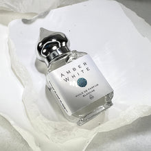 Load image into Gallery viewer, Amber White 10 ml Gift bottle with a pointed shiny cap. You can use your finger to dab this elegant perfume on.