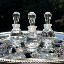 Cargar imagen en el visor de la galería, Clear Glass Potion Genie Bottles on a silver tray sparkling in the sunshing. Imagine colorful perfume oils inside. GORGEOUS!