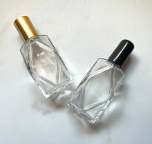 Cargar imagen en el visor de la galería, 2 oz. Diamond Style Perfume Bottles lying on their side with a black and gold cap option.