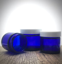 Load image into Gallery viewer, 1 oz. Cobalt blue straight sided cosmetic jar with white lined lid option. High quality UV proof glass. Safe for all essential oil products.