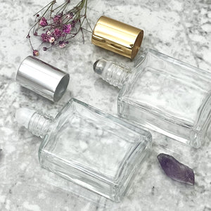 15 ml Roll on Bottle perfume. A perfume Roll On. Clear glass with caps off to showcase insert options.