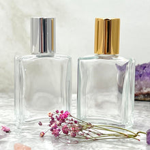 Load image into Gallery viewer, The Parfumerie offers 15 ml flat glass roll on bottles with silver and gold caps. These are luxury perfume bottles.