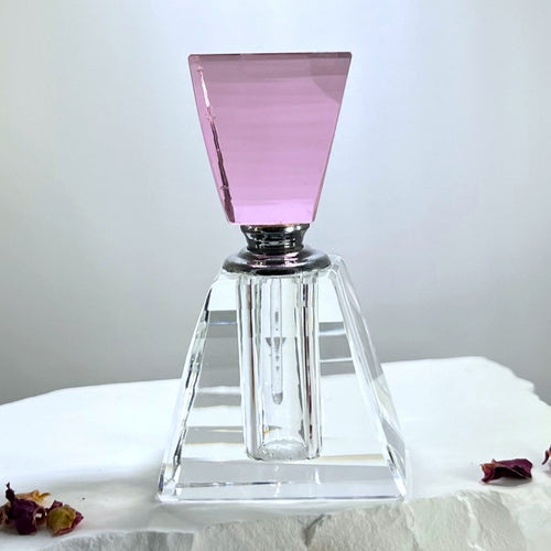 A refillable Perfume Bottle with a pink keystone top and glass meel. An empty perfume bottle for Egyptian Musk.