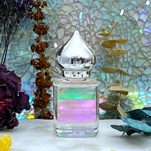 Perfume Oil at The Parfumerie in a clear perfume bottle with a pointed cap. Elegant.