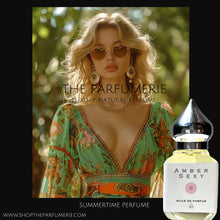 Load image into Gallery viewer, Amber Sexy perfume. A woman with sunglasses and summer dress wearing Amber Sexy perfume.