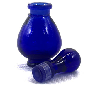 Clear glass Potion Genie Bottle with Top off so you can see the ground glass stopper with plastic ring. 