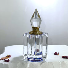 Cargar imagen en el visor de la galería, An empty perfume bottle that is a refillable perfume bottle for attar perfume. Clear, blue base, pointed top.