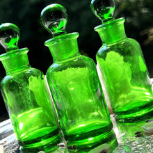 Load image into Gallery viewer, GREEN Glass Apothecary Bottles in one ounce size on a silver tray sparkling in the sunshine.