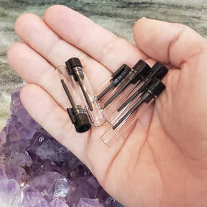 Clear glass vials, size 7/8 ml in the palm of a human hand to show comparison of size. Perfect aromatherapy products or craft supplies.