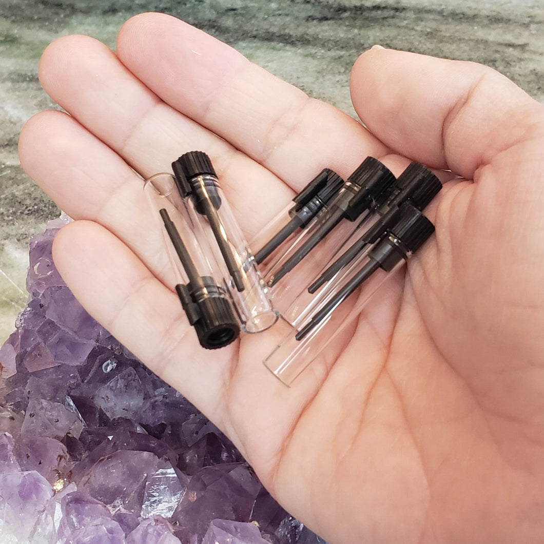 Clear glass vials, size 7/8 ml in the palm of a human hand to show comparison of size. Perfect aromatherapy products or craft supplies.