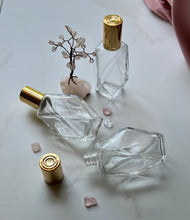 Load image into Gallery viewer, Glass Bottles with Gold Caps. 1 lying down to show the neck of the bott.e