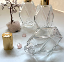 Load image into Gallery viewer, The 2 oz Diamond Style Perfume Bottle. 1 lying on it&#39;s side tto make the neck visible.