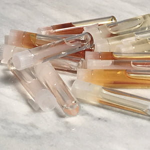 Glass vials with natural/opaque applicator wands. Great for holding glitter or pins or any type of crafts!