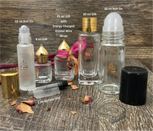 Load image into Gallery viewer, Various perfume bottles to show the different sizes offered. 1ml sample vial, 10ml Roll On Bottle, 8ml Gift Bottle, 15ml Gift with Energy charged Crystal wire wrap, 30ml Gift Bottle and 30ml Roller Bottle. All of these perfume bottles are clear except the 10ml Roller Bottle is frosted.