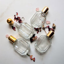 Load image into Gallery viewer, Half Ounce Fancy Roll On Perfume Bottles come in clear glass with a plastic insert and gold cap.