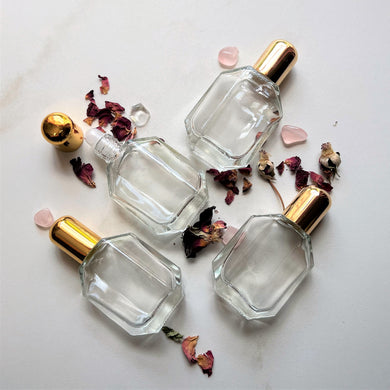 Half Ounce Fancy Roll On Perfume Bottles come in clear glass with a plastic insert and gold cap.