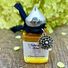 Load image into Gallery viewer, 15 ml Tuberose attar in a clear Gift Bottle with Silver pointed minaret cap and Nunn Design Charm.