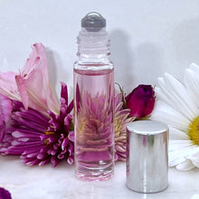 Cargar imagen en el visor de la galería, 10 ml Clear Glass Roller Bottle with Stainless Steel Rollerball Insert showing and Silver Cap on the side of the bottle.