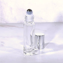 Load image into Gallery viewer, 10 ml Clear Glass Roll On Bottle with a Stainless Steel Rollerball Insert and Silver Shiny Cap. The perfect bottle for Essential Oils.