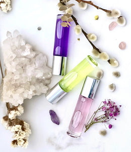 Glass Roll On Bottles filled with perfume oils that show the elegance of the colors within the bottles. Makes a great Gift!