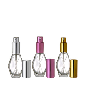 Perfume Bottles. Diamond Glass Atomizer Spray Bottles with a Silver, Purple and Gold spray top and over cap. Sizes available are 1/2 oz., 1 oz. and 2 oz.