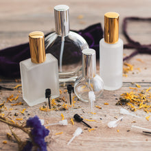Load image into Gallery viewer, Assorted Perfume Bottles. Our focus is the 2 oz. Perfume Spray bottle. Frosted Glass with Gold Atomizer Sprayer Top and Over Cap for Perfume Oils, Essential Oils or Fragrance Oils.